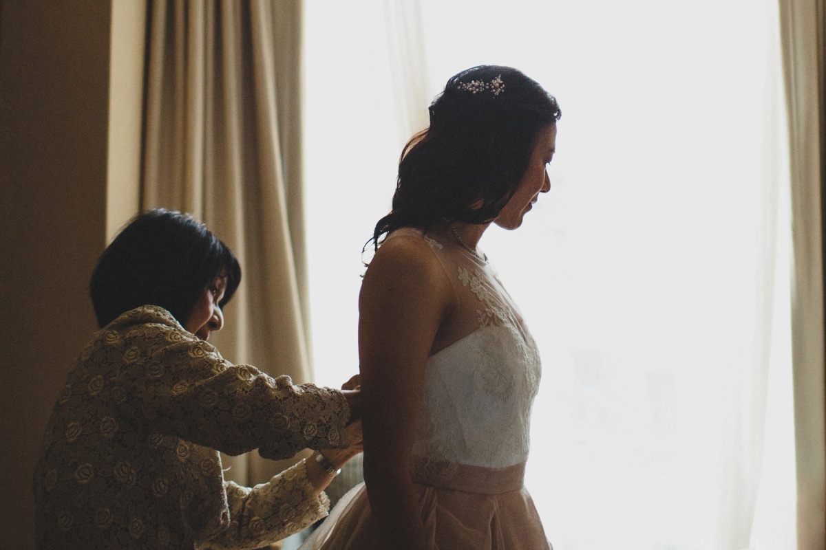 bride-putting-on-dress