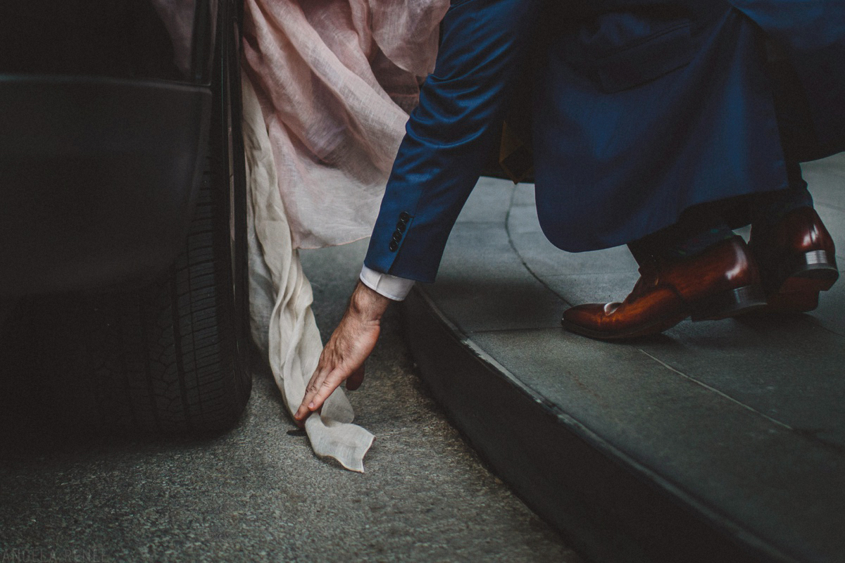 groom-carries-brides-dress