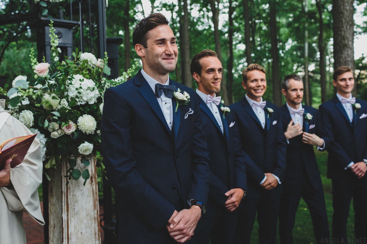 groom-looks-at-bride-down-aisle