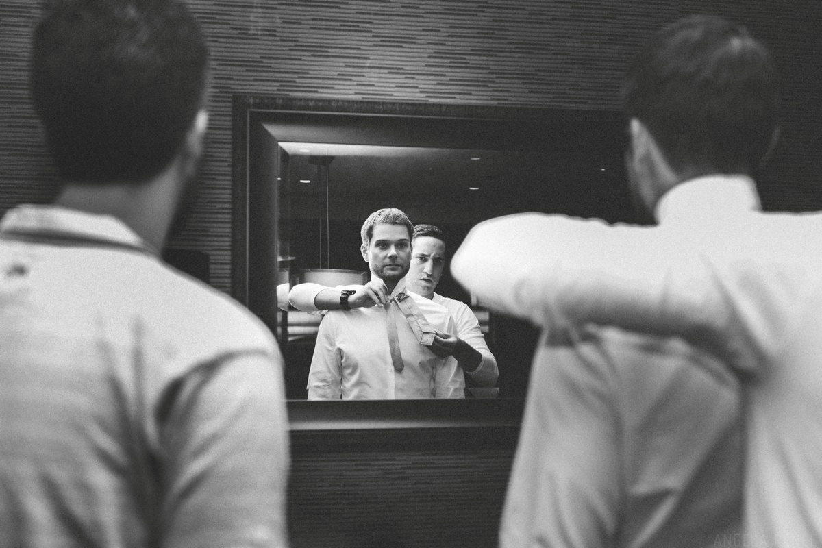 groom getting ready in the mirror