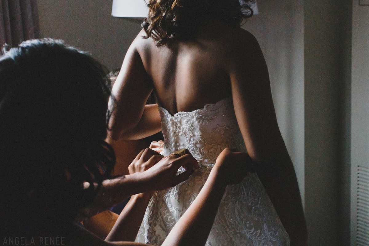 bride putting on dress