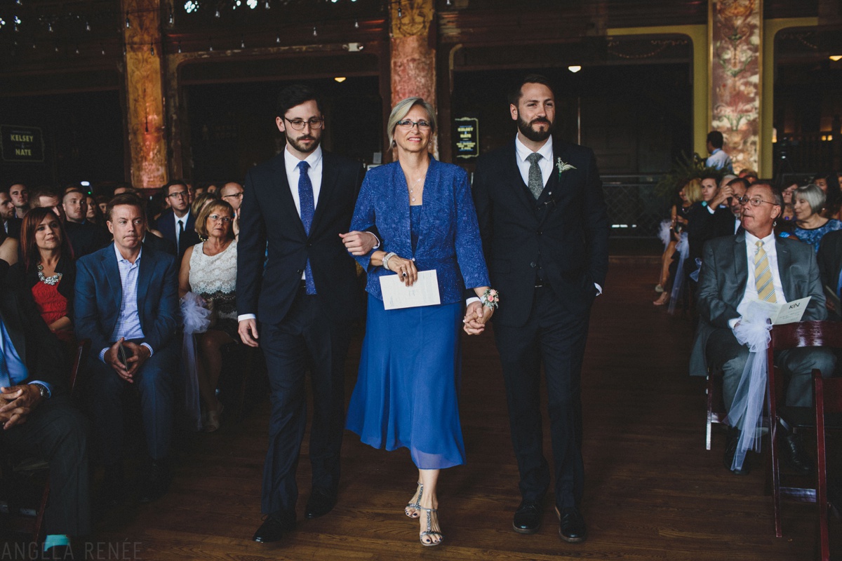 groom walks mom up aisle